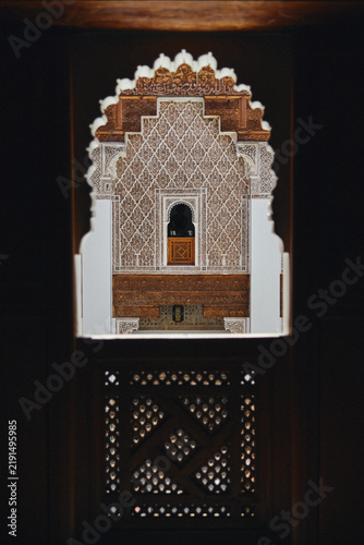 Quadro su tela View through a carved wooden screen towards an ornate Moroccan alcove