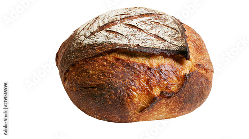 Фотография Round sourdough bread loaf with dark crispy crust and flour dusted top