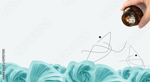 Fotografie Line art of fish in the ocean, bottle of pills in human hand