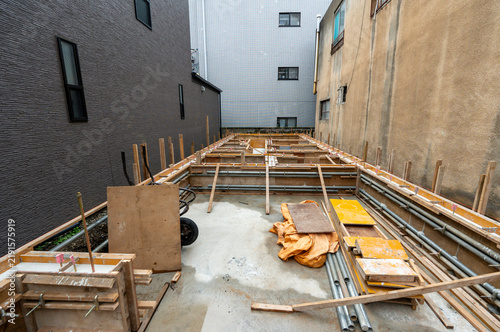 Concrete foundation and wooden formwork for narrow urban house