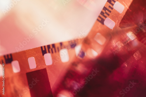 Vintage analog photo film stripes with light leaks and bright lens flare, scratch distressed texture with soft colorful glow, retro cinematic abstract  photography overlay background.