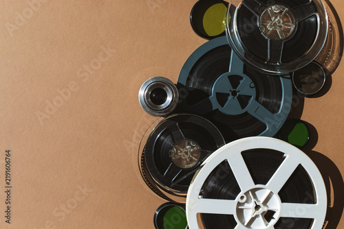 Vintage analog video reels and old tape films collection for projector, retro filmmaking and videography equipment, archival records for home movie background top view.