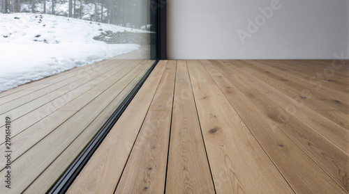 Zero threshold transition featuring a flush mounted linear drain channel and level matched wide plank oak decking