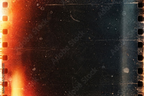 Vintage black film frame with orange light leak overlay for cinematic editing and retro visual transitions