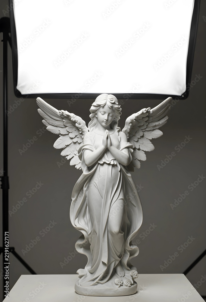 Fototapeta premium Spirituality and peace marble angel statue with praying hands for religious memorial funeral service and divine grace in studio lighting