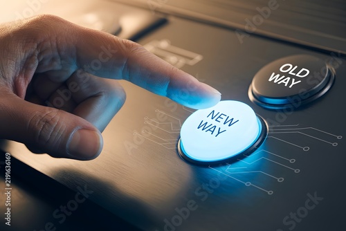 Human hand pressing a glowing new way button to choose a different approach for future innovation