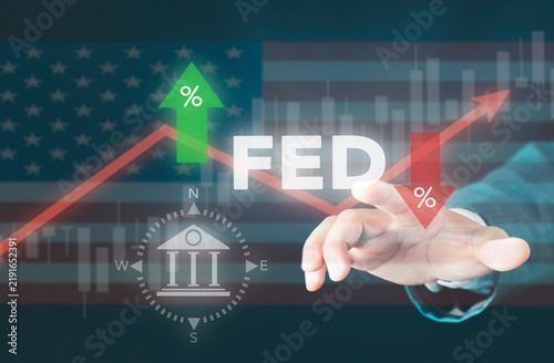 Businessman touching FED interest rate change concept. Federal reserve rate cut and hike, central bank policy, stock market growth graph, percentage arrow, and US economy.