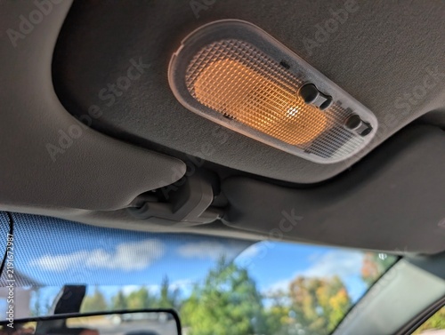 Foto Car interior dome light glowing warm light on grey ceiling