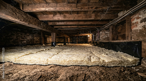 Fiberglass insulation in residential crawl space | Old house crawl space encapsulation | Energy efficiency home improvement underfloor insulation | Crawl space moisture barrier protection