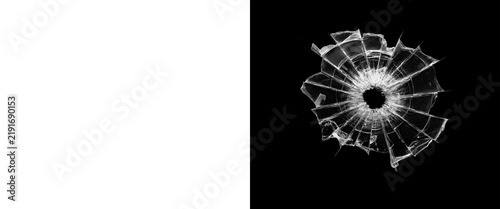 Shattered glass bullet hole on black background, broken window texture overlay, cracked glass screen effect for design