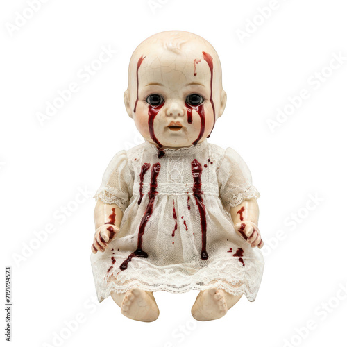 Creepy vintage doll with blood stains on face and dress isolated on transparent background