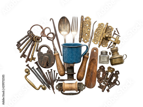 Assorted vintage kitchen tools and utensils arranged in a circular composition.