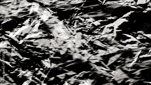 Plastic wrap texture overlay effect on black background. Shrink wrapped plastic sleeve for cover. White plastic