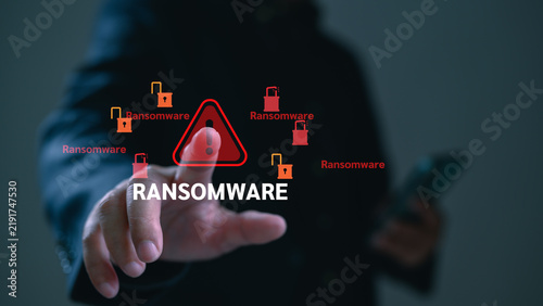 Fotografie Hacker executes cyberattack ransomware malware holding files hostage, as ransom threat warning alerts cyberattack victim against malware extortion danger