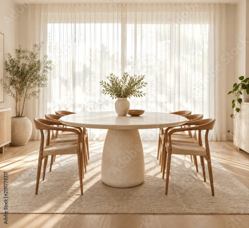 Modern minimalist dining setup with round light wood and stone table, natural greenery, soft natural lighting, cozy neutral-toned room for home entertaining or family meals