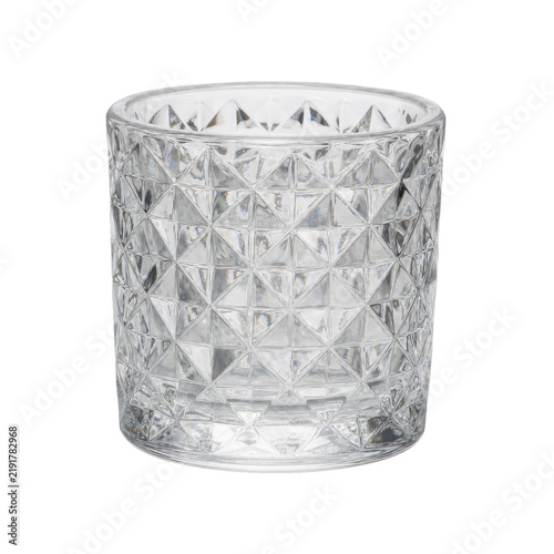 Foto Clear glass votive candle holder with a geometric faceted pattern, captured with