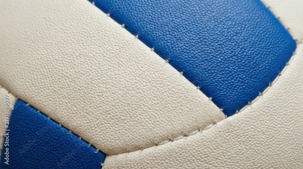 Obraz premium Close up macro view of the textured surface of a blue and white volleyball with visible stitching