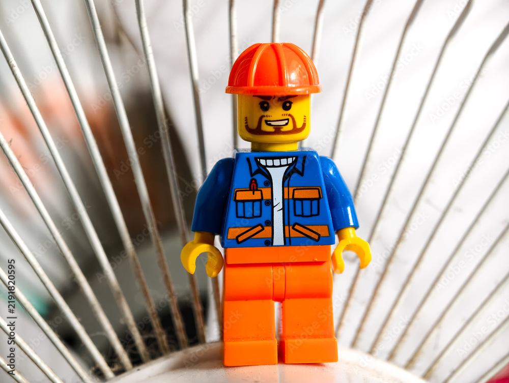 Fototapeta premium Russia, St. Petersburg, August 8, 2020 A close-up shot of a Lego man wearing a hard hat, ideal for use in illustrations or designs requiring a small, detailed figure