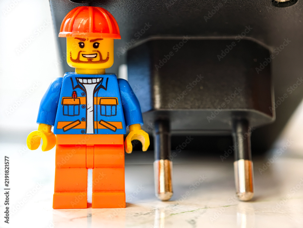 Obraz premium Russia, St. Petersburg, August 8, 2020 A small Lego man standing next to an electrical outlet