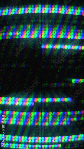 Chromatic CRT monitor scanline glitch texture with bright rainbow colors and digital signal noise distortion.