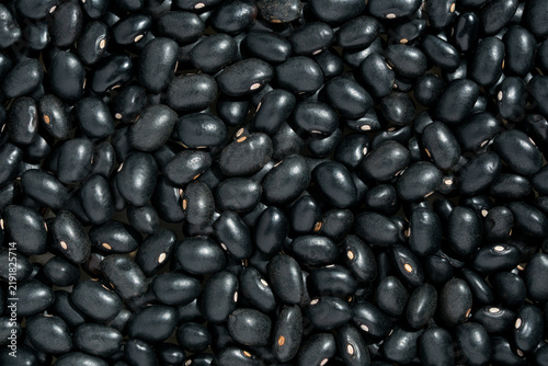 Raw organic black turtle beans texture background.