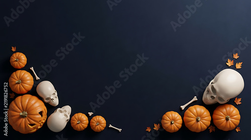 Orange pumpkins and human skulls arranged in a flat lay on a dark blue background