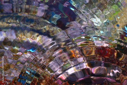Fotografie The ripples on the coloured water’s surface allow us to observe the phenomena of refraction and wave interference