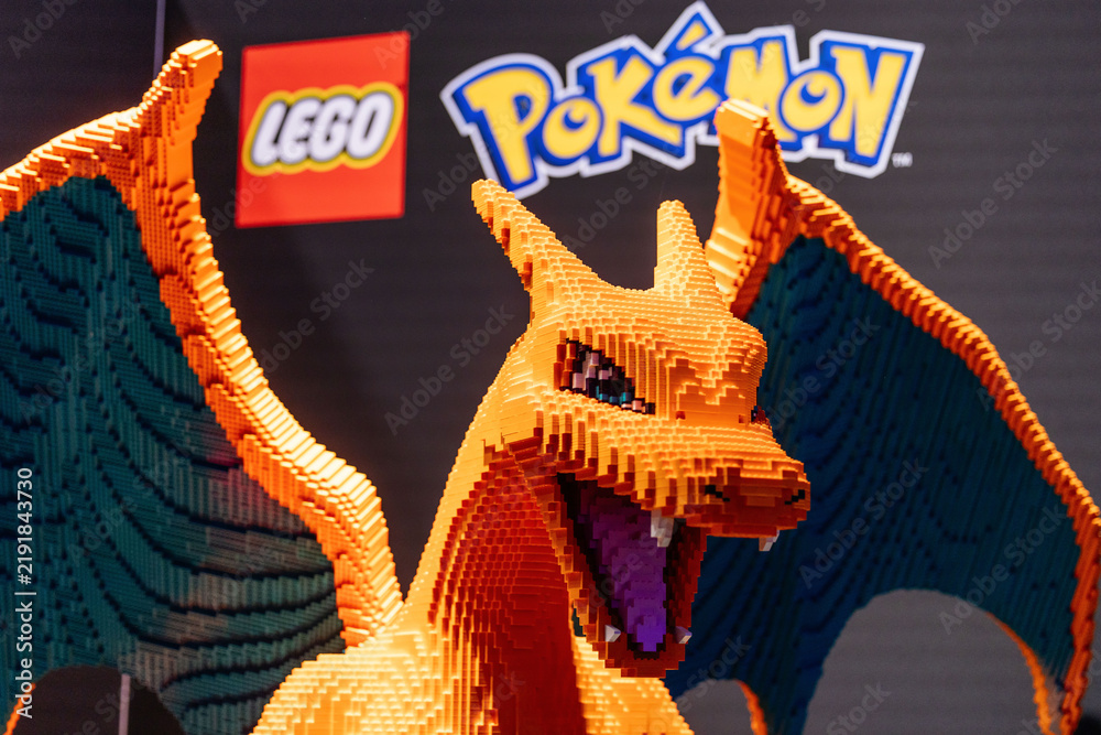 Fototapeta premium Cologne, Germany - August 26, 2026: LEGO Charizard sculpture displayed at gamescom, featuring vibrant orange and green colors, showcasing intricate brick details and iconic Pokemon branding