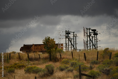 Obraz na plátně Close view of decommissioned substation disconnect switches under storm clouds i