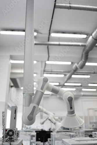 Fotografie Industrial Robotic Arm in Modern Automated Manufacturing Facility