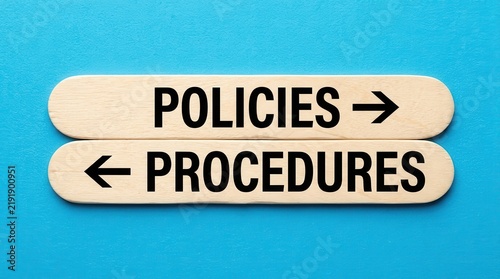 Business procedures and policies concept with text on wooden sticks.