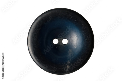 Detailed macro shot of a round textured dark blue sewing button