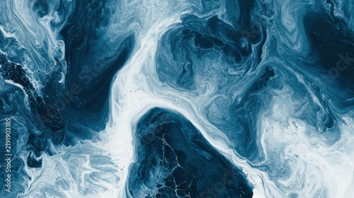 Overhead view shows prussian blue fluid mixed with milk, creating a dramatic contrast of very dark blue and white, resembling ocean depths.