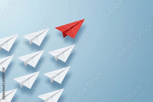 Red paper airplane leading white planes on blue background leadership concept