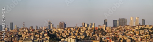 View of the modern skyline and dense residential buildings at sunset, with warm golden light illuminating the urban landscape of Istanbul, Istanbul, Turkiye.