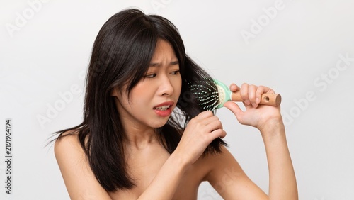 Canvastavla Worried Asian Woman In Early Adulthood Struggling With Tangled Hair While Brushing, Sitting At Home