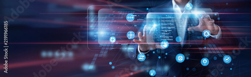 Software developer working on virtual screen. Programmer checks API (Integration) frameworks and cloud data flow graphs on a hologram display. System architecture and digital networks.