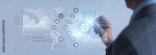 Software developer point of API (Integration) building network connectivity links. Programmer seamlessly combining software applications on a virtual screen to optimize system operations.