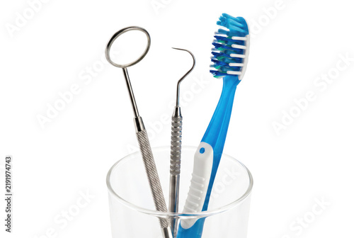 Obraz na płótnie Professional Dental Instruments and Blue Toothbrush in Glass