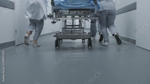 Medical team rushing hospital stretcher through corridor during emergency