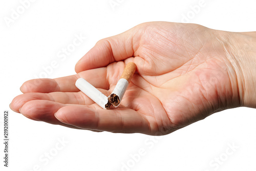 Foto Open palm holding a snapped cigarette representing the decision to quit smoking