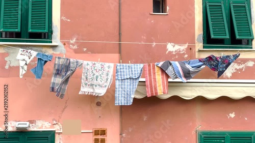 Drying laundry on outdoor clothesline. Traditional Italian street domestic habits. Eco friendly sustainable house chores.