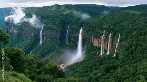 Nohsngithiang Falls cascade down lush green cliffs in Meghalaya during monsoon. Majestic tropical landscape perfect for travel and environmental conservation themes.