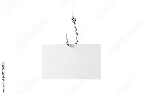 White card pierced by a fishing hook hanging from a string