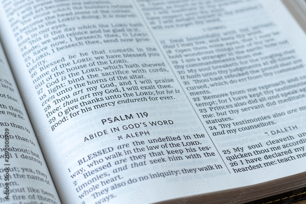Obraz premium Psalm 119 in open holy bible book. Abide in God's word. Wisdom and obedience to Jesus Christ, biblical concept.