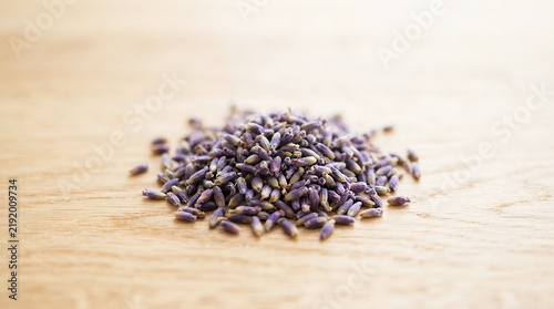 Dried Lavender Buds Scattered on a Light Wood Surface, Natural Rustic Background