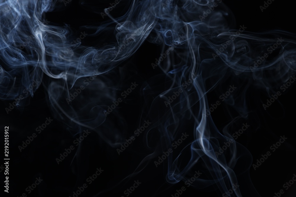 Obraz premium Beautiful smoke in light on black background