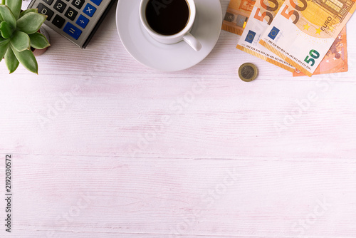 Creative border with cup of coffee, vintage calculator, vjney and succulent flower on white wooden background with copy space for your design top view. 
