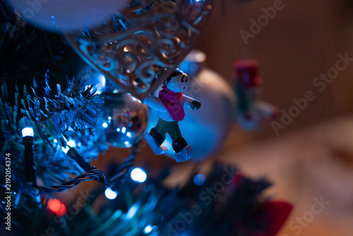 Christmas tree ornament illuminated by Christmas lights—a ice skater