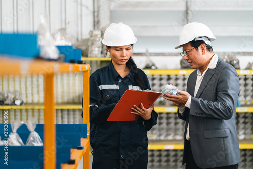 Fotografie Asian engineer and manager reviewing industrial safety checklist in factory